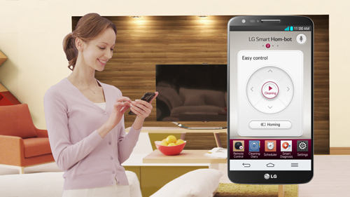 A woman using her phone to remotely control LG HOM-BOT