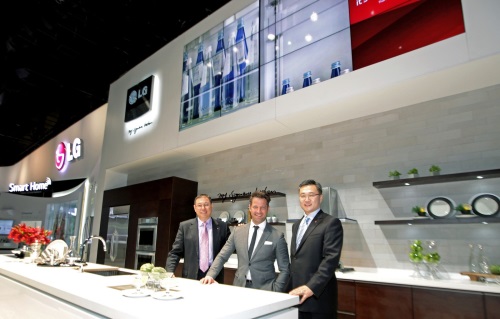 Top product designer Nate Berkus and two men from LG standing in concept kitchen featuring LG Studio lineup at CES 2014