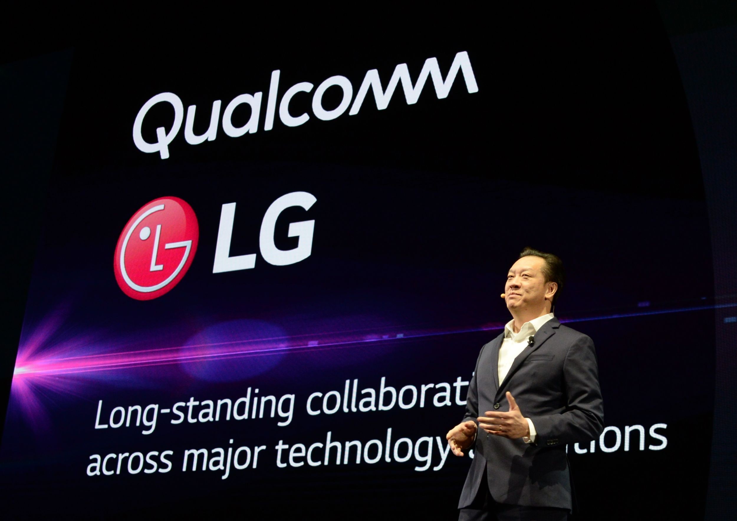 David VanderWall, Senior Vice President of Marketing at LG Electronics USA and Tim Alessi Senior Director of Product Marketing for Home Entertainment Products at LG Electronics USA are onstage demonstrate the half-rolled display position of the LG SIGNATURE OLED TV R at LG's CES 2019 Press Conference while putting the TV between them.